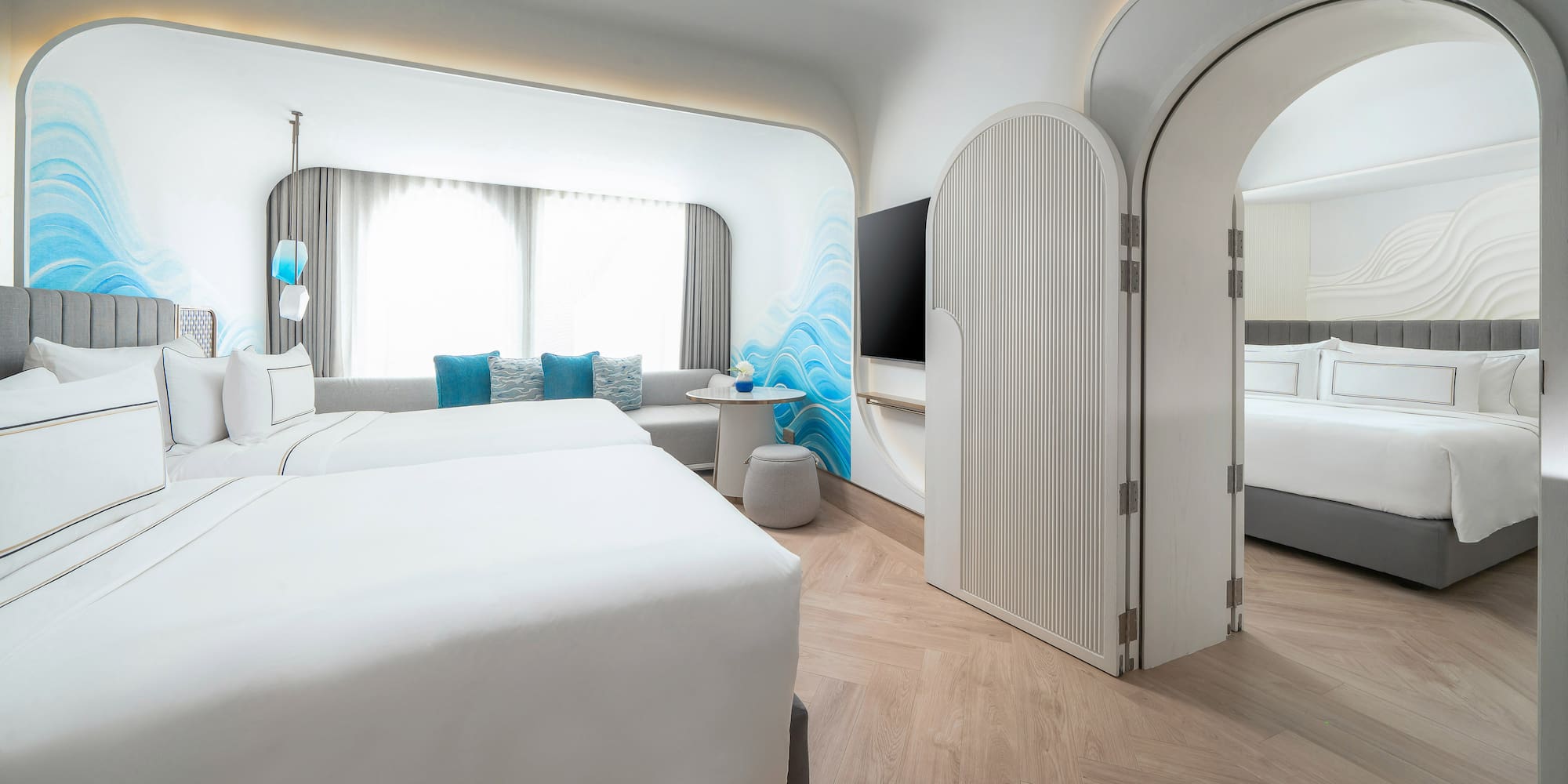 a room with two beds and a tv