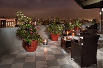 a patio with plants and candles on it
