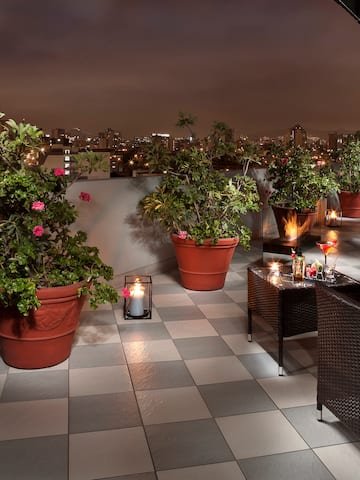 a patio with plants and candles on it