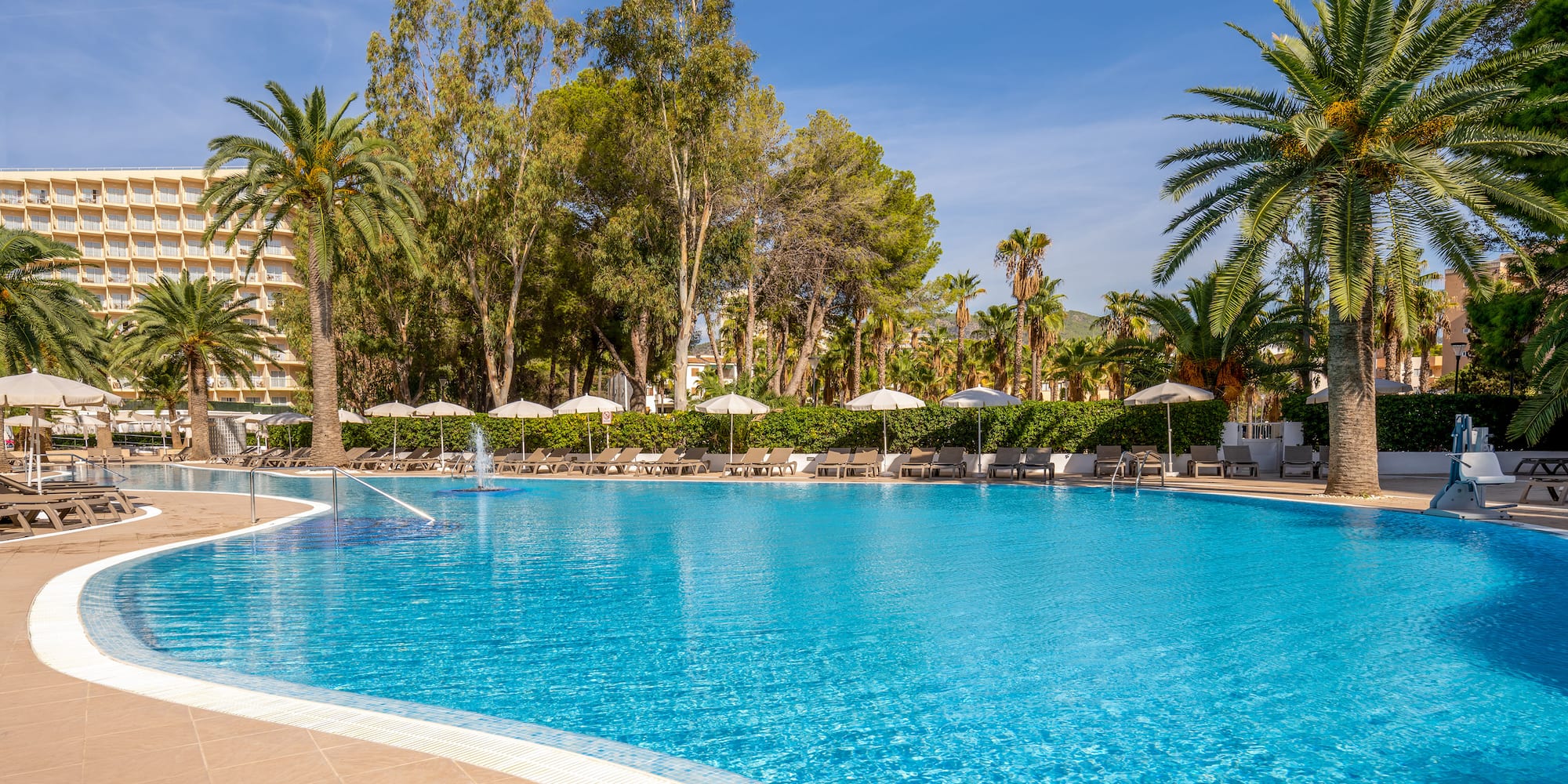 a pool with umbrellas and chairs
