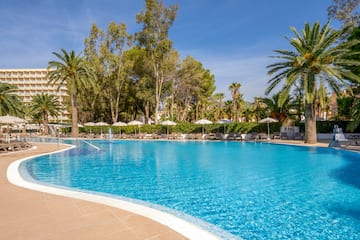 a pool with umbrellas and chairs