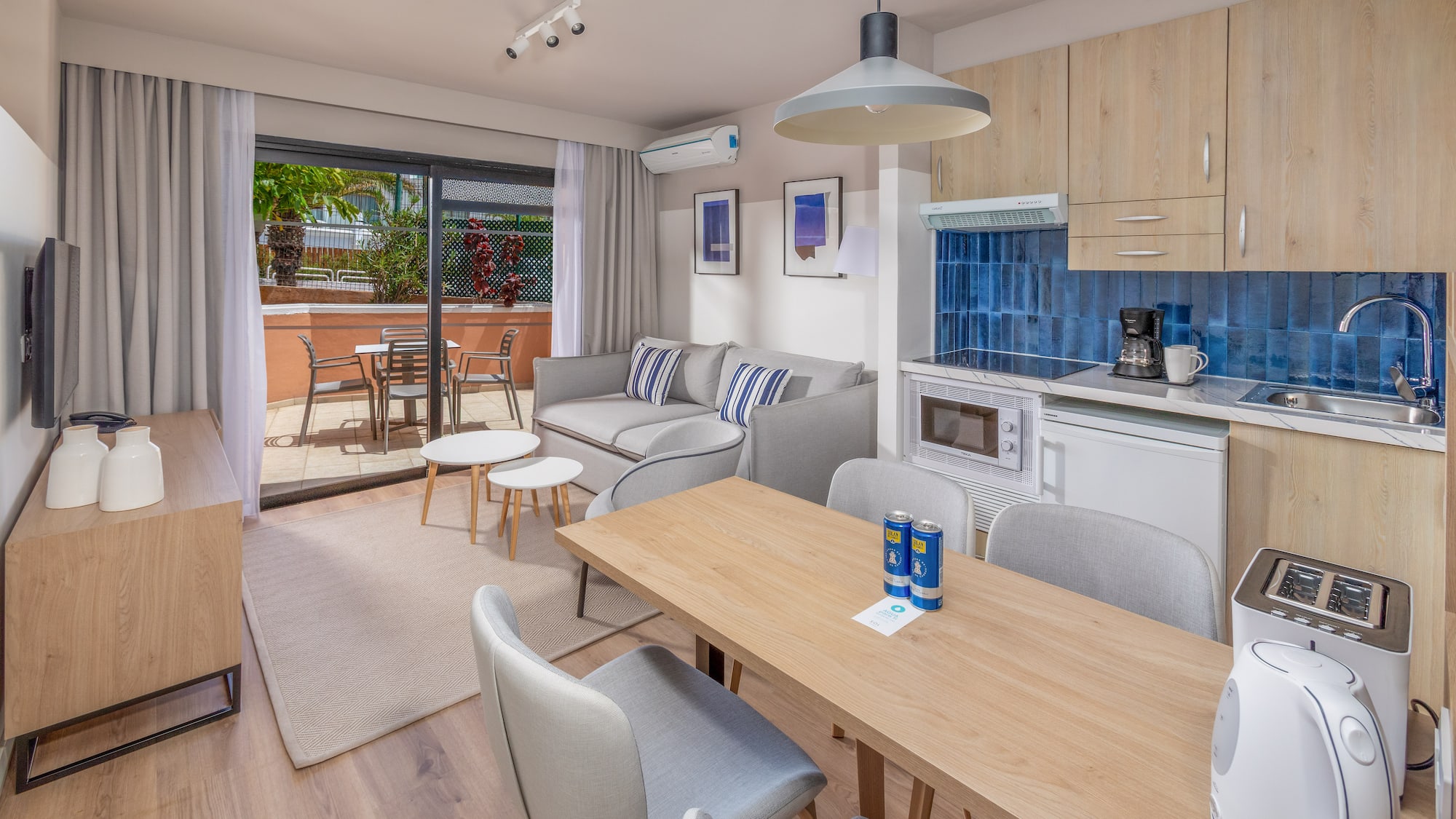 Modern apartment with open-plan living room, kitchen, dining area, and balcony.