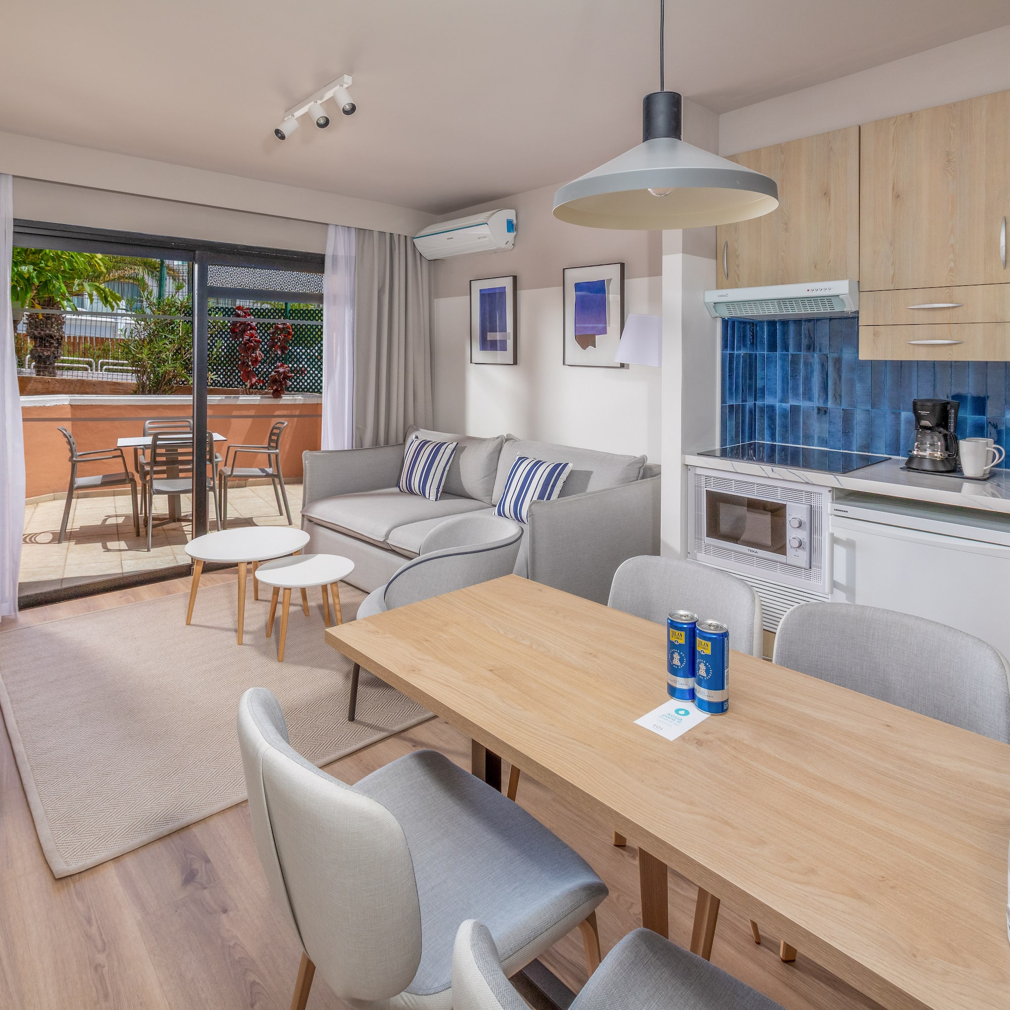 Modern apartment with open-plan living room, kitchen, dining area, and balcony.