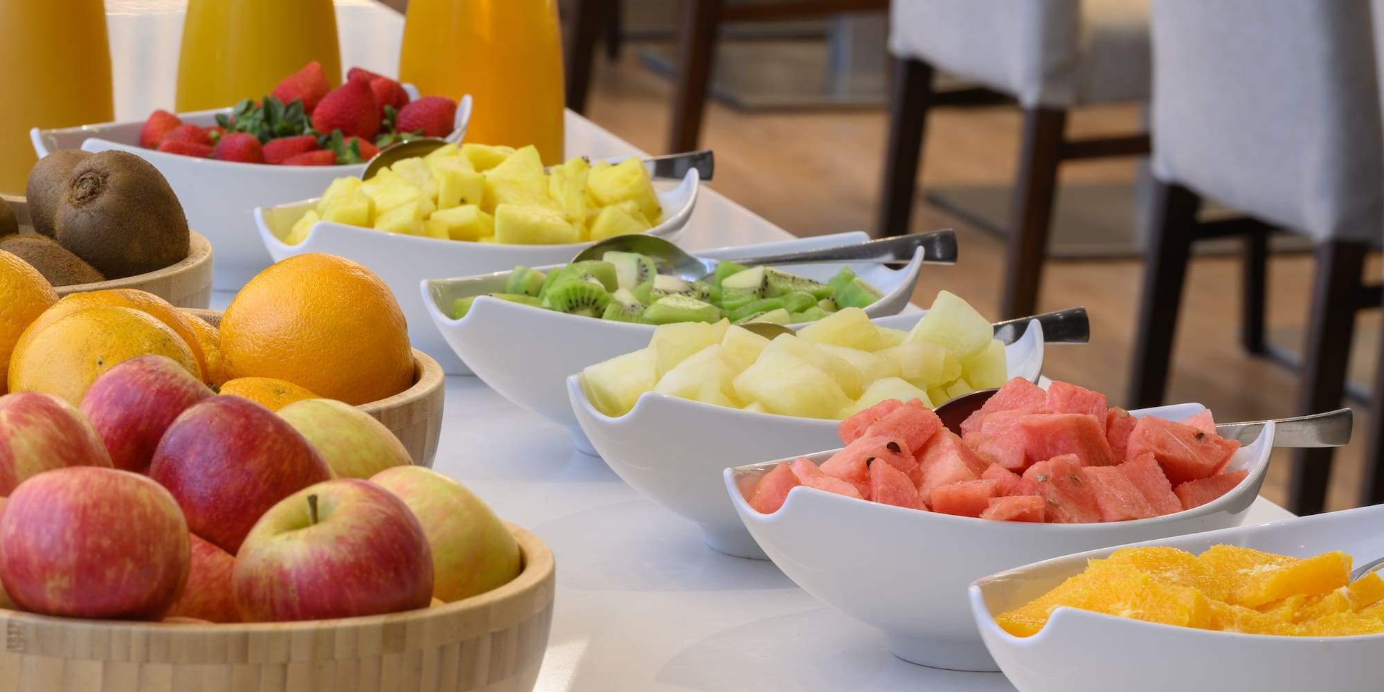 a table with bowls of fruit