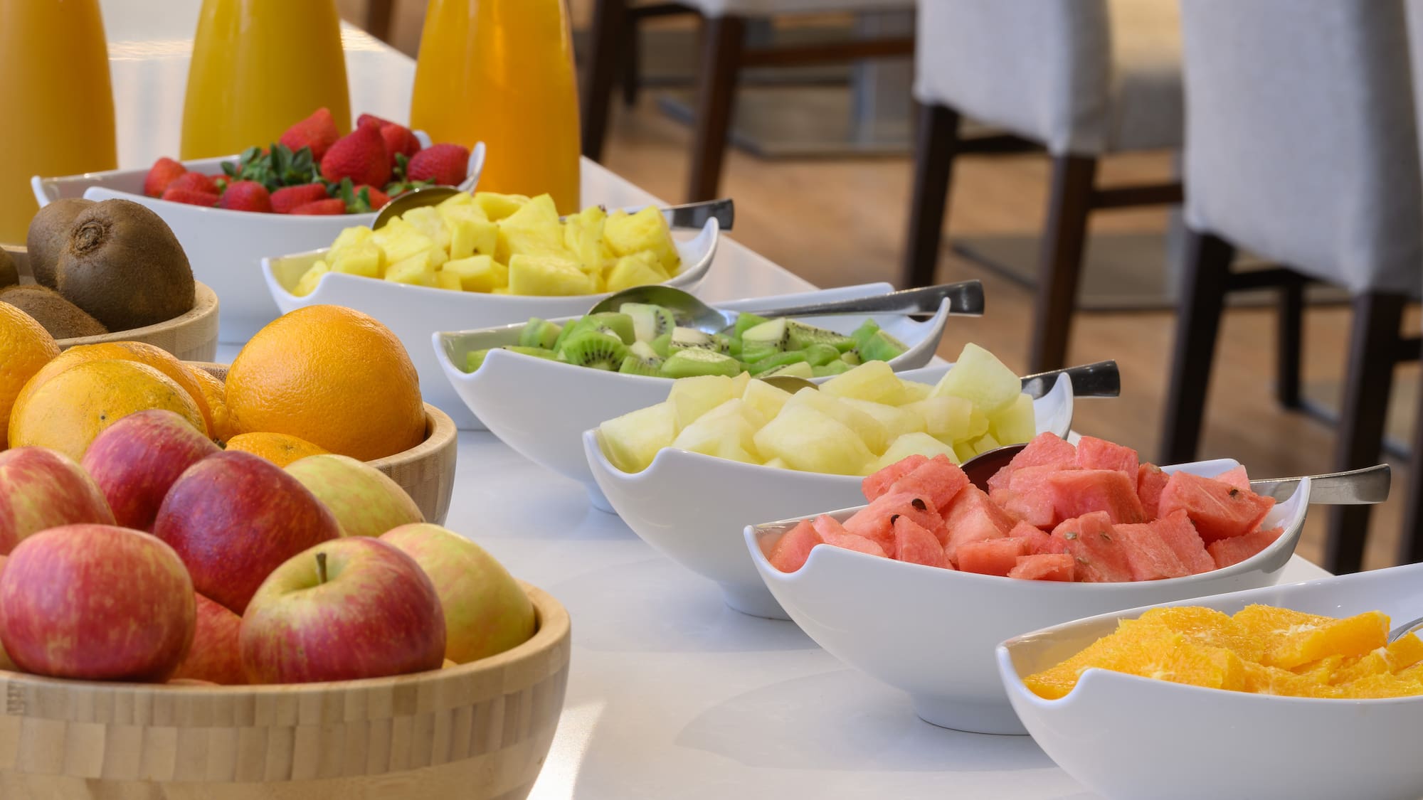 a table with bowls of fruit