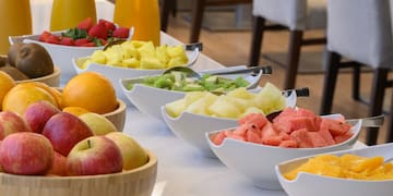 a table with bowls of fruit