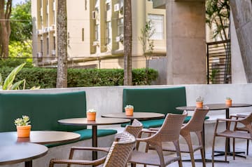 a table and chairs outside with a building in the background