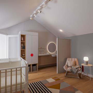 a room with a crib and a rug