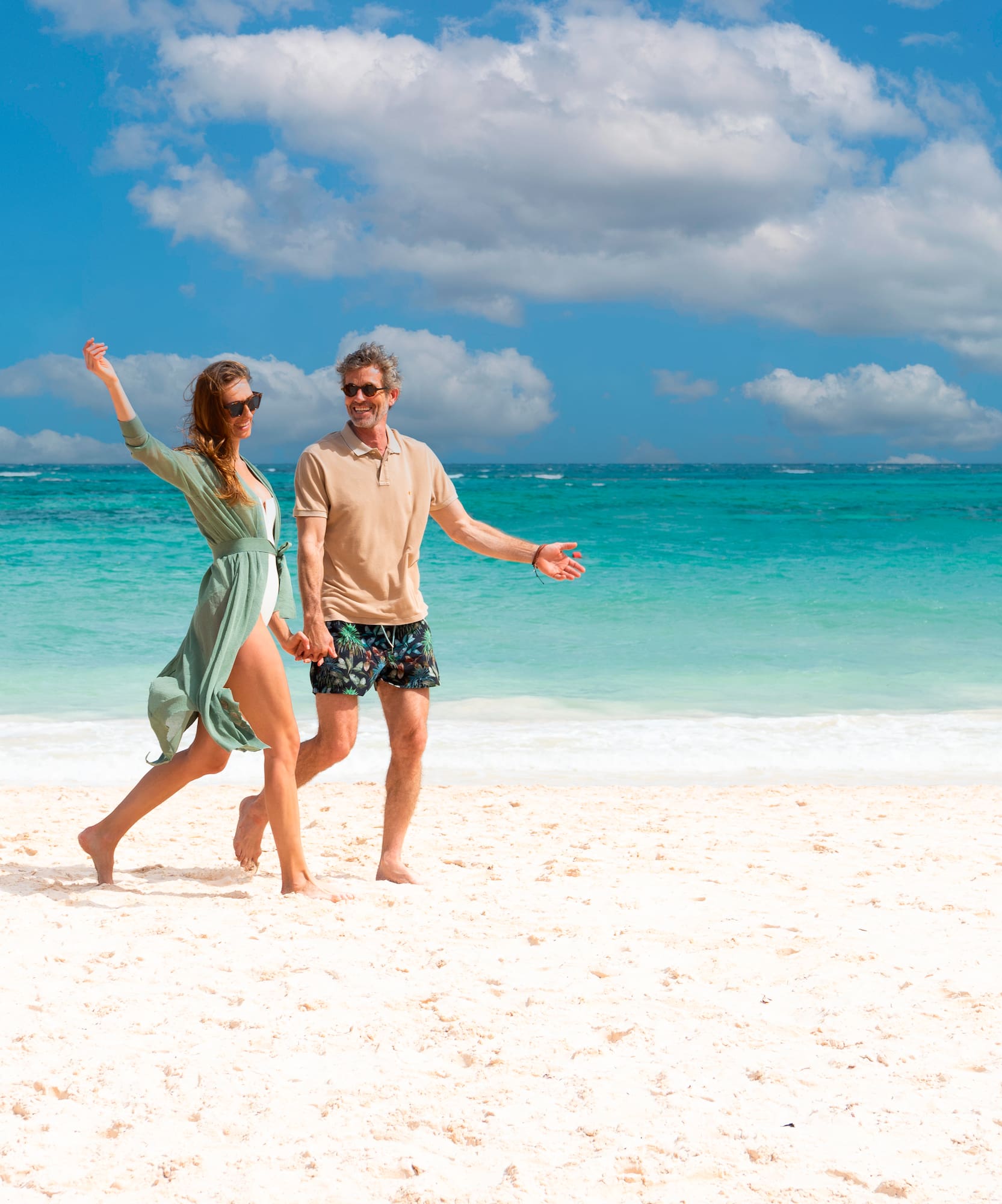 a man and woman on a beach.