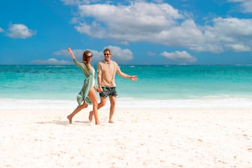 a man and woman on a beach.