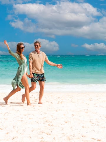 a man and woman on a beach.