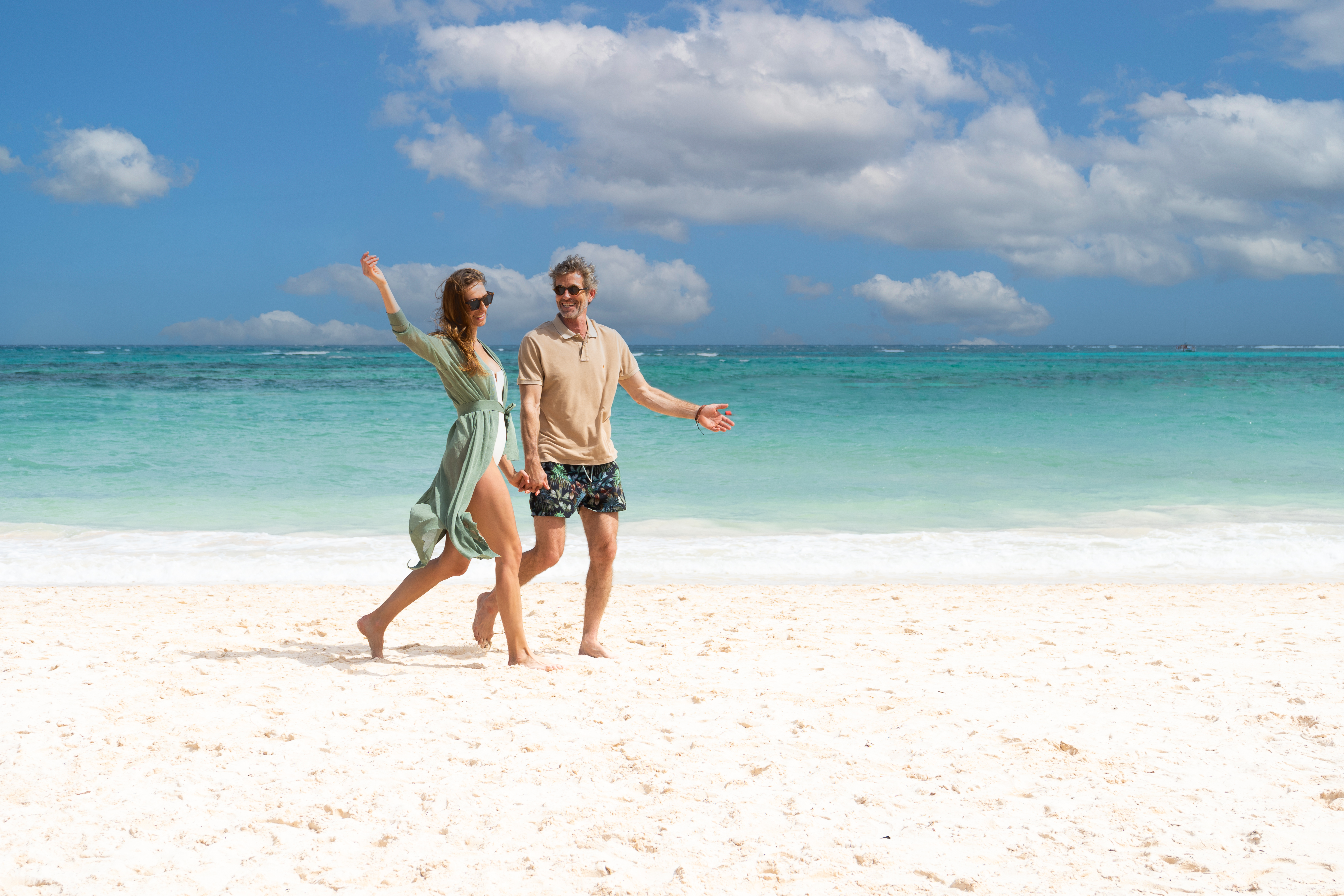 a man and woman on a beach.