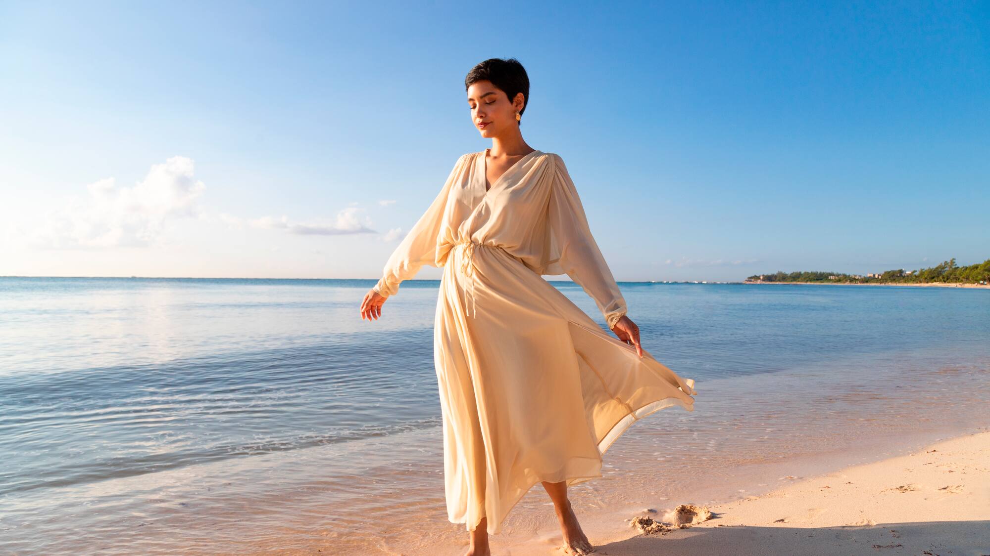 a woman in a dress on a beach