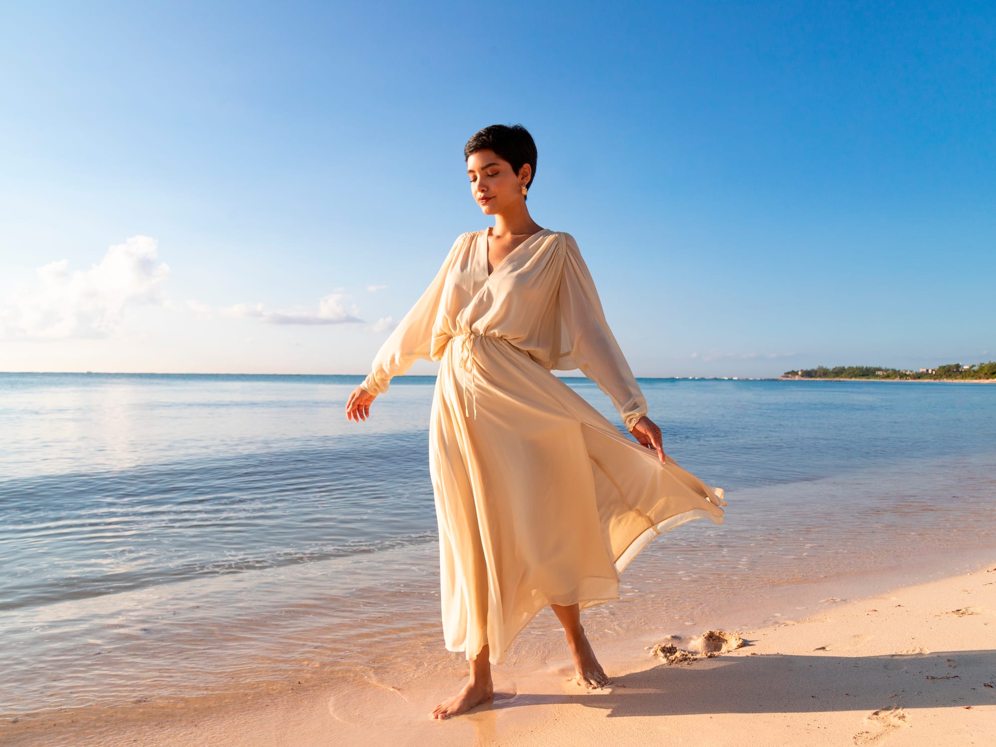 a woman in a dress on a beach