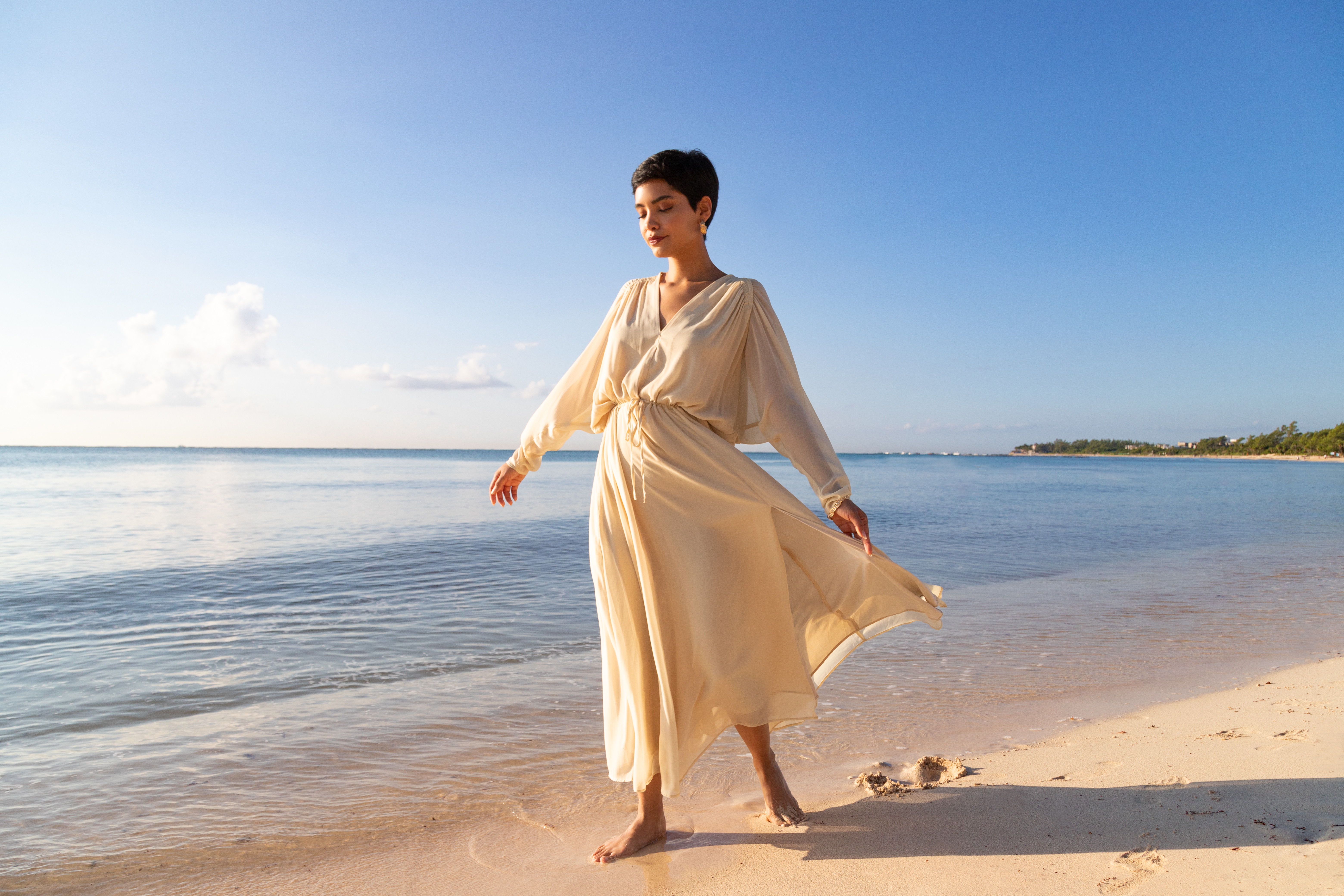 a woman in a dress on a beach