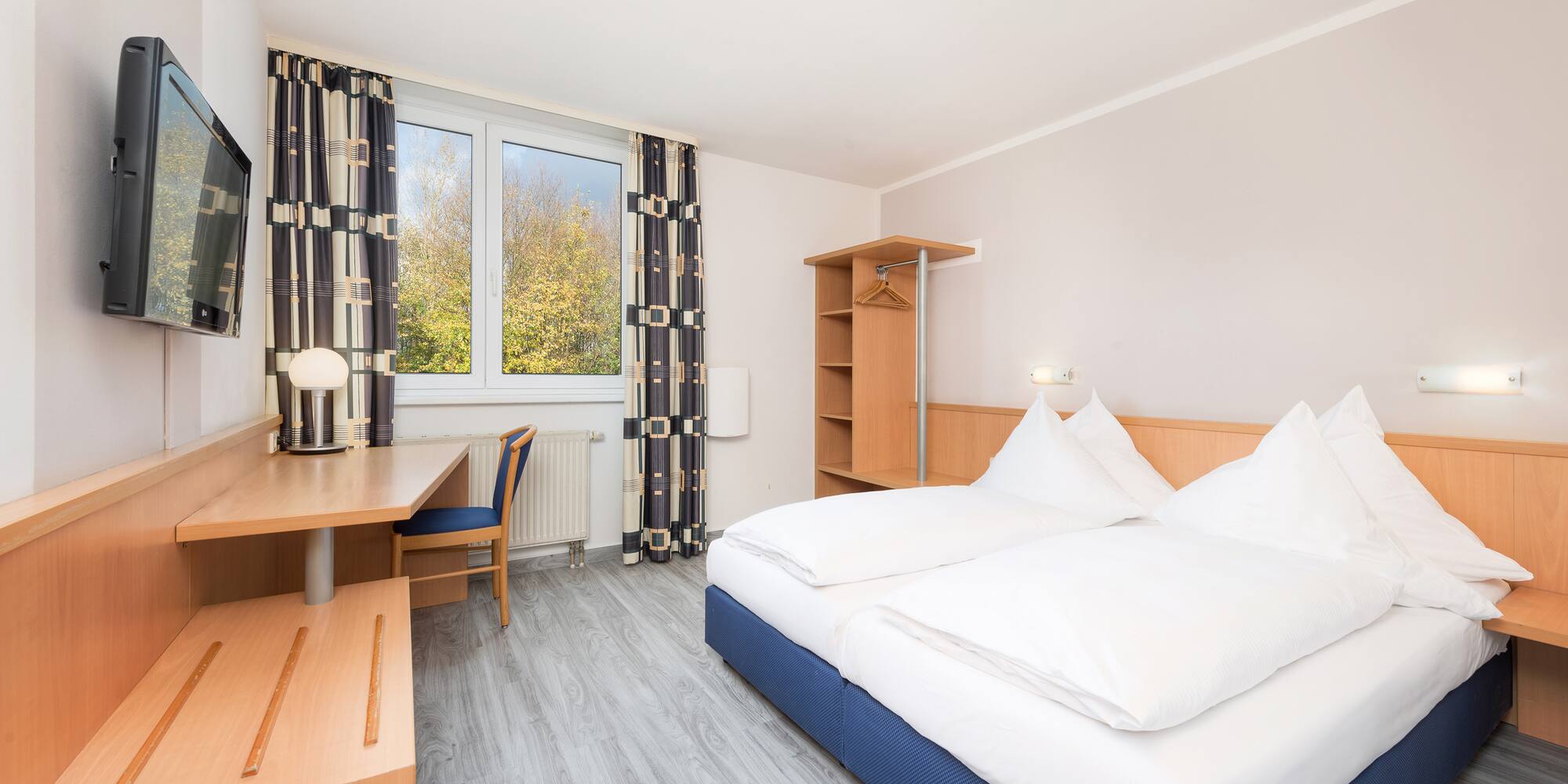 a room with a bed and desk