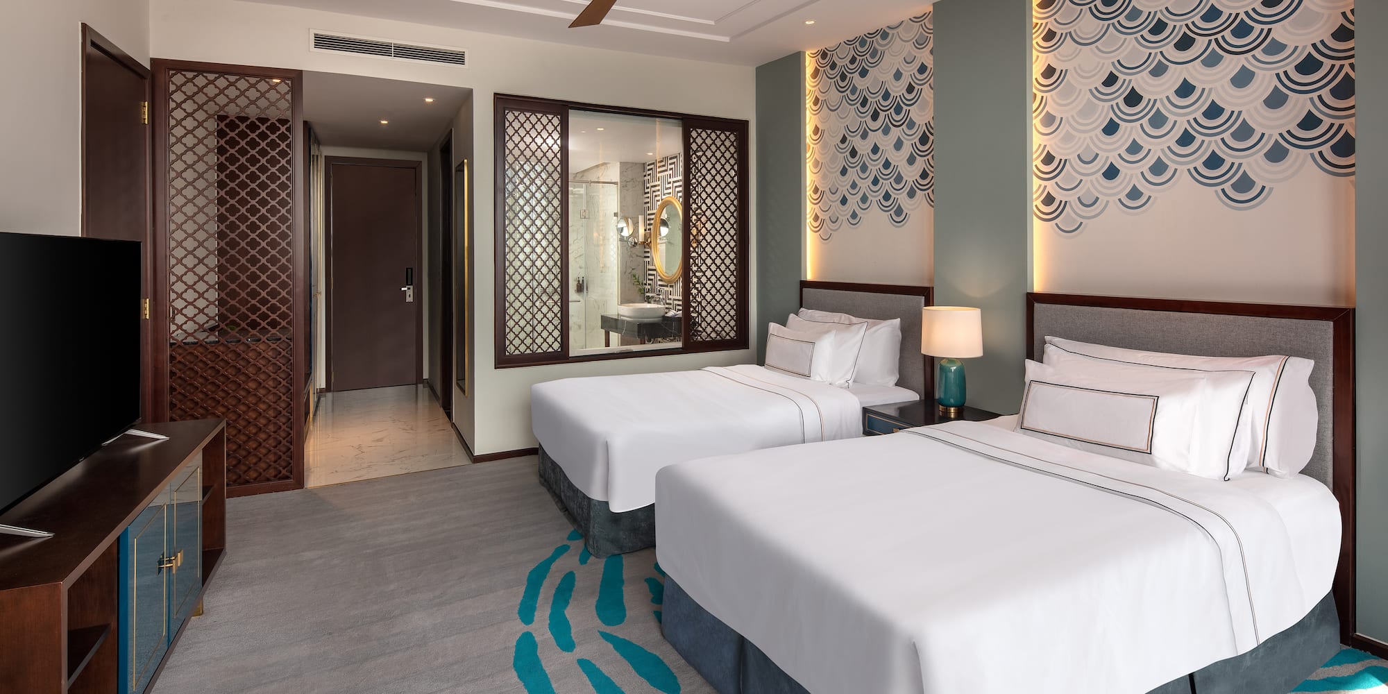 a room with two beds and a fan