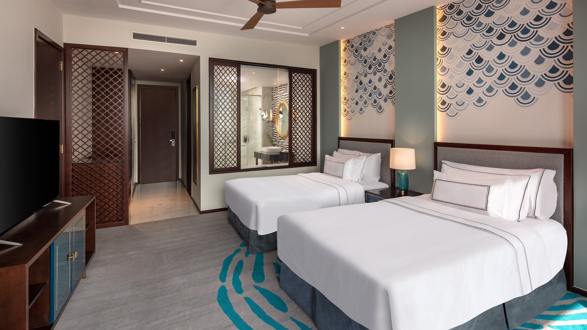 a room with two beds and a fan