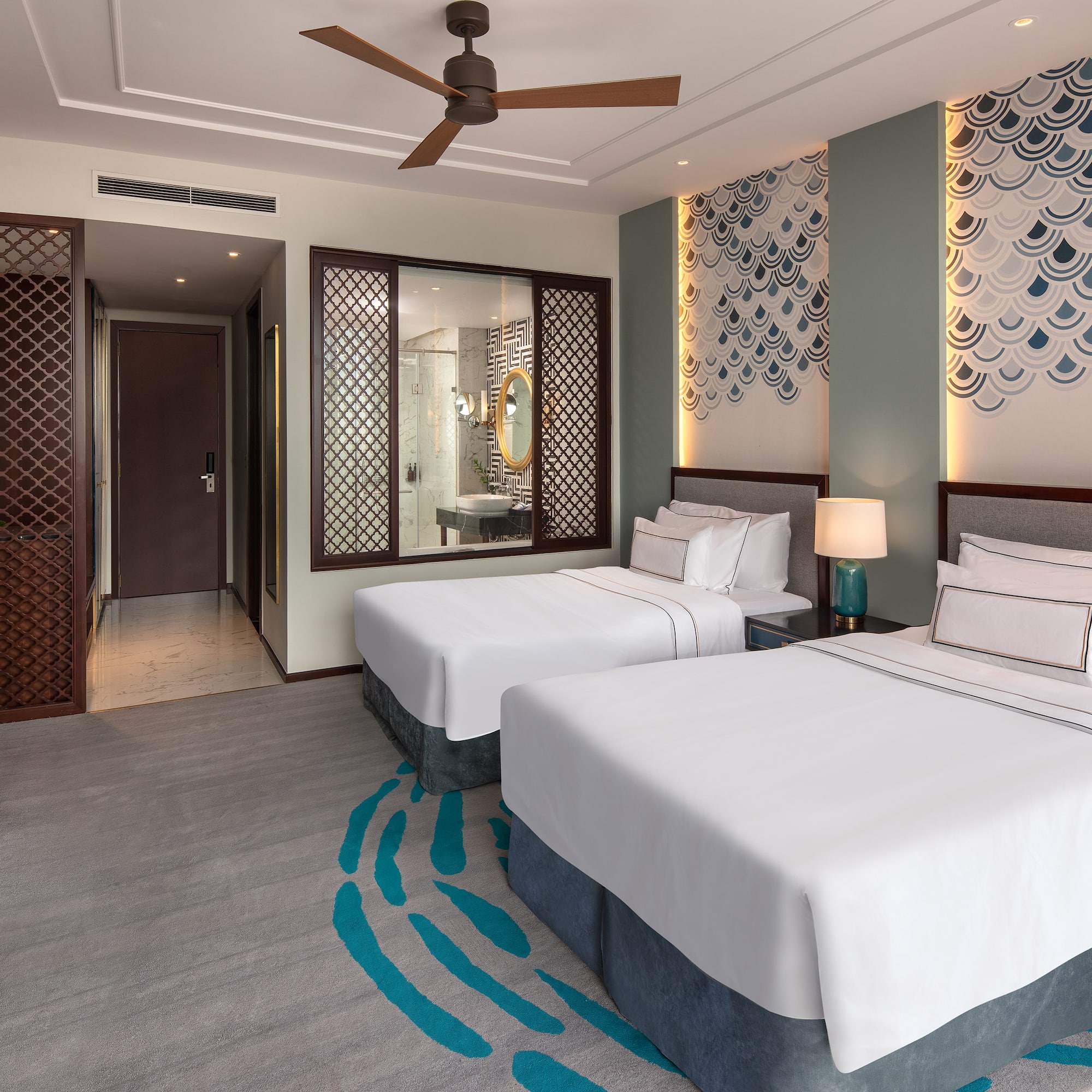 a room with two beds and a fan