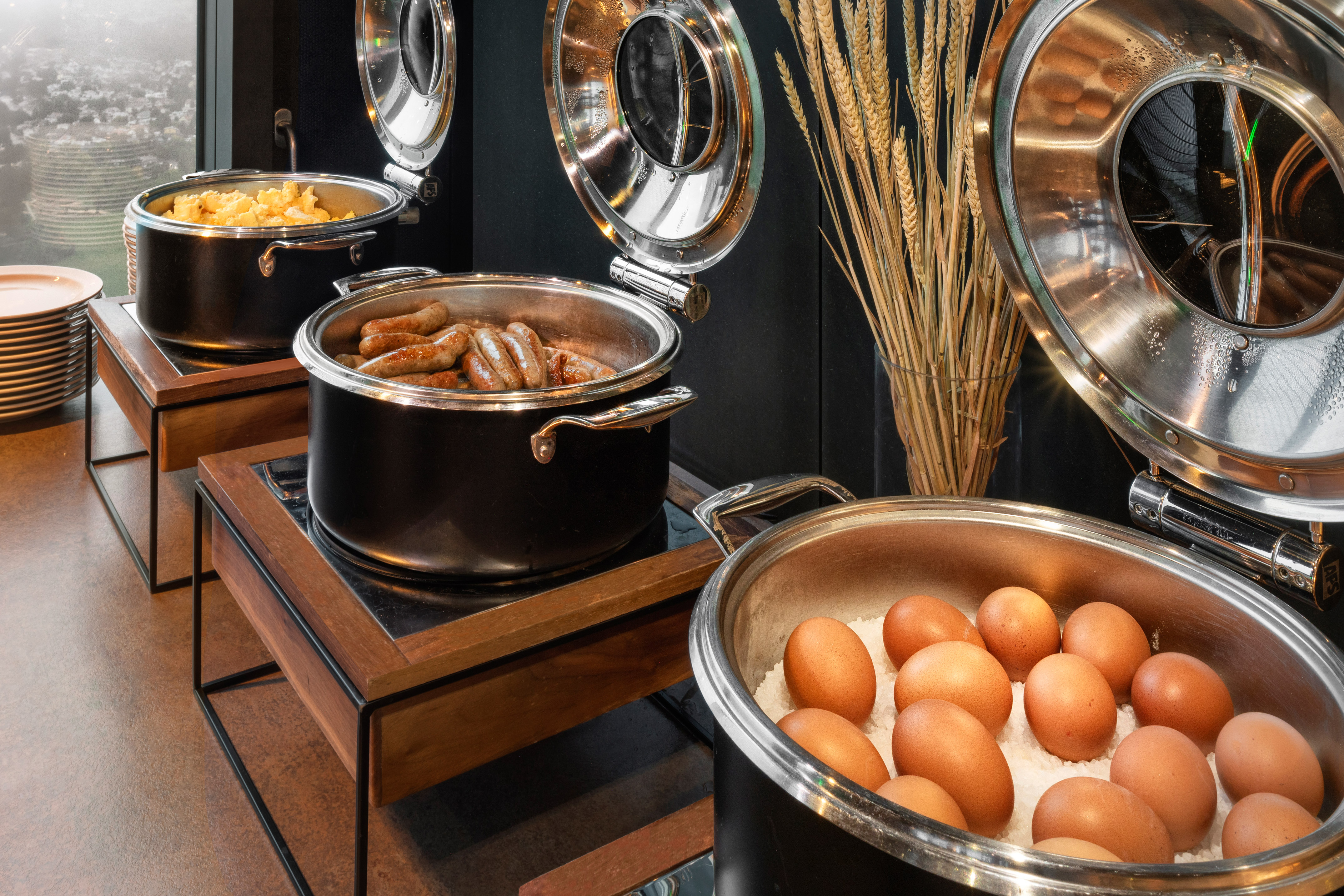 Full breakfast buffet featuring scrambled eggs, sausages, and hard-boiled eggs.