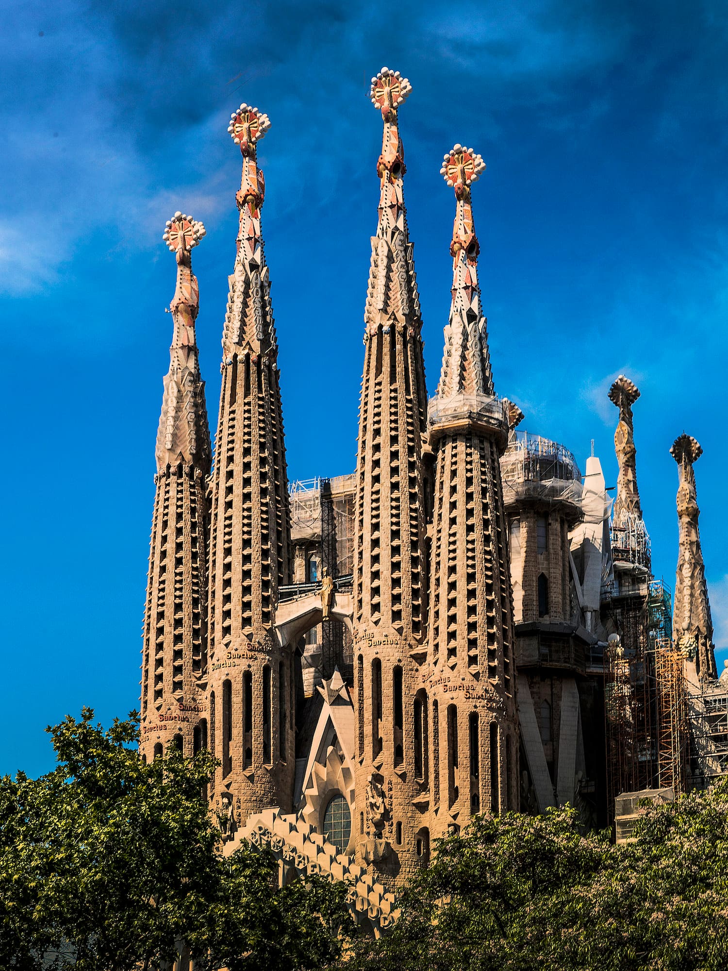 a large building with many spires with Sagrada Família in the background
