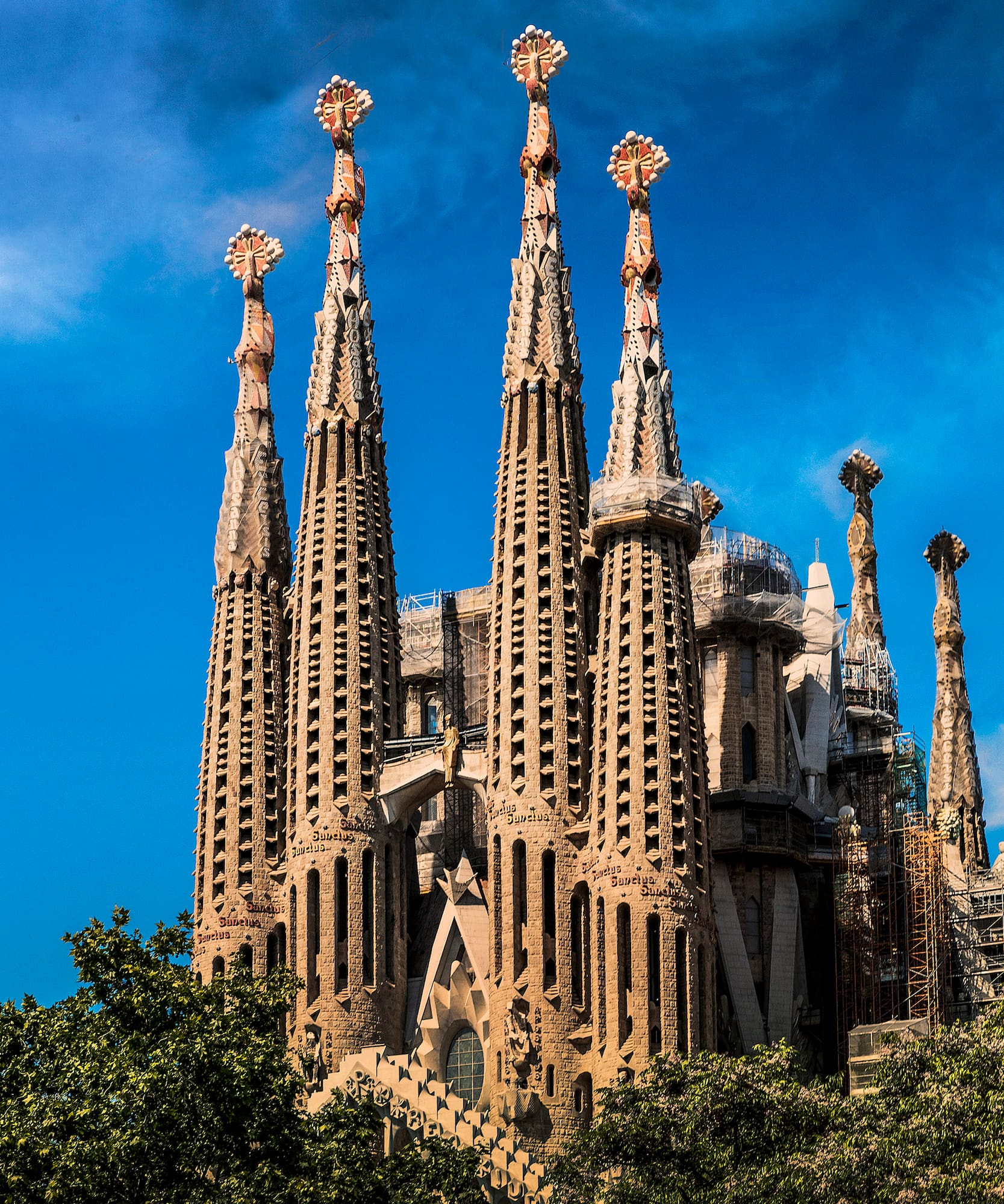 a large building with many spires with Sagrada Família in the background
