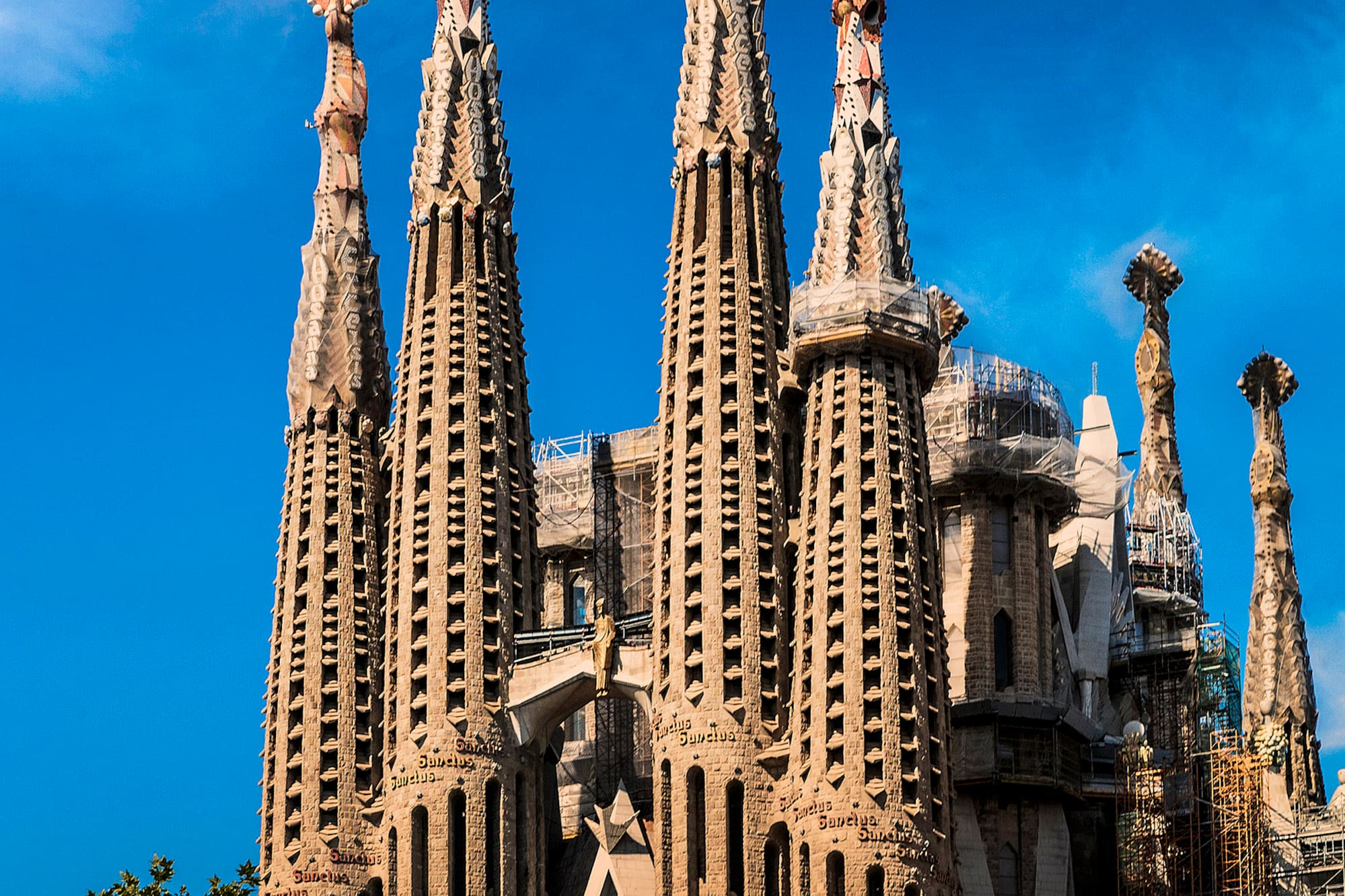 a large building with many spires with Sagrada Família in the background