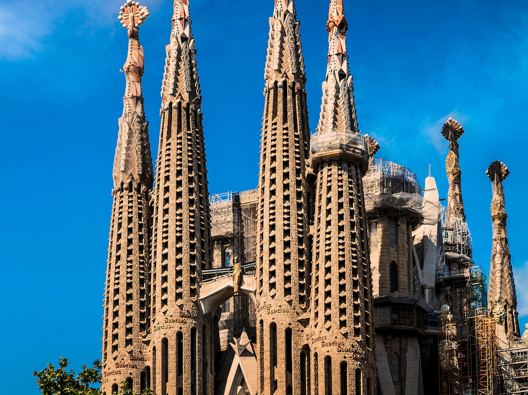a large building with many spires with Sagrada Família in the background