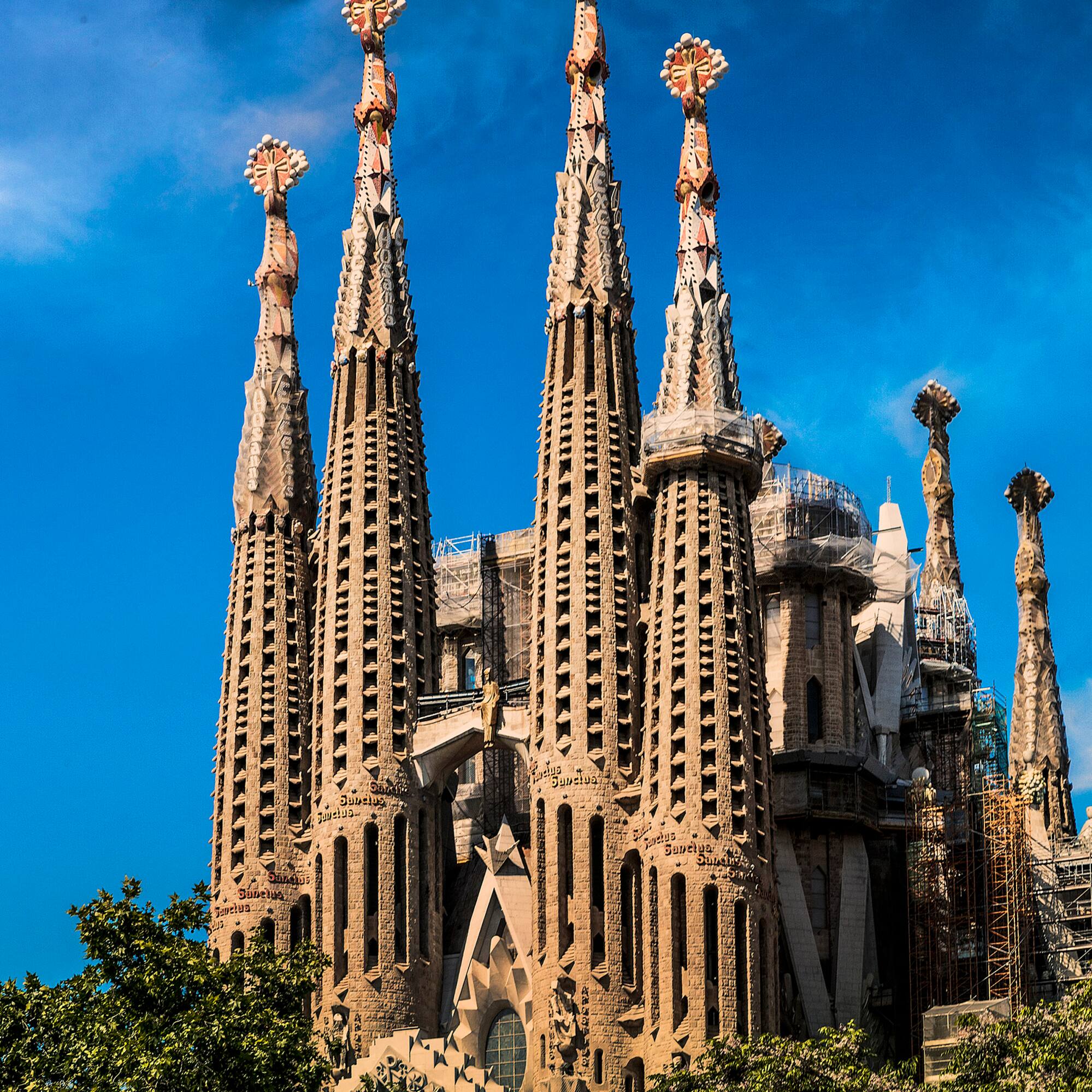 a large building with many spires with Sagrada Família in the background