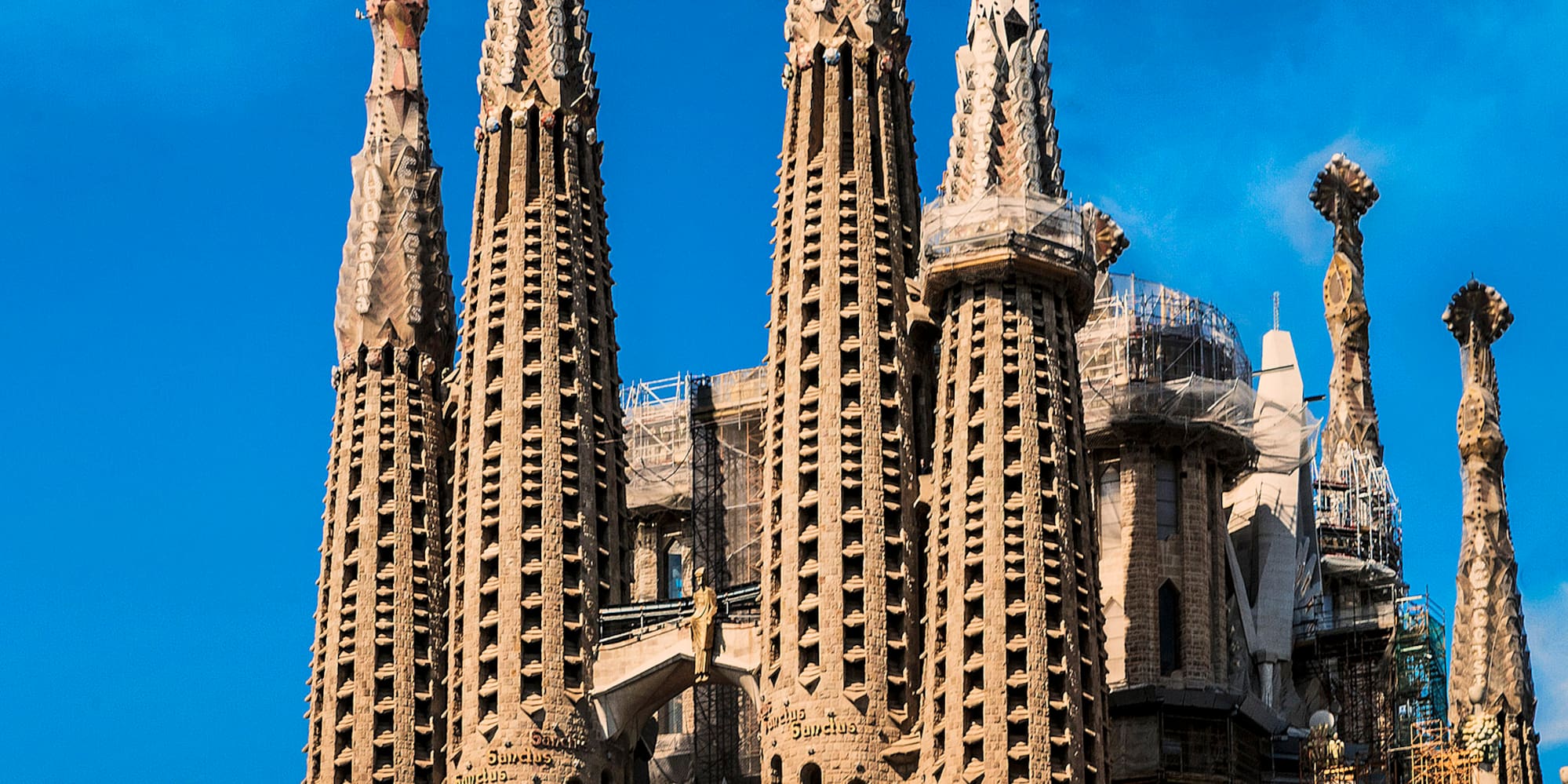 a large building with many spires with Sagrada Família in the background