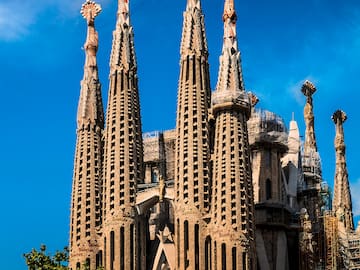 a large building with many spires with Sagrada Família in the background