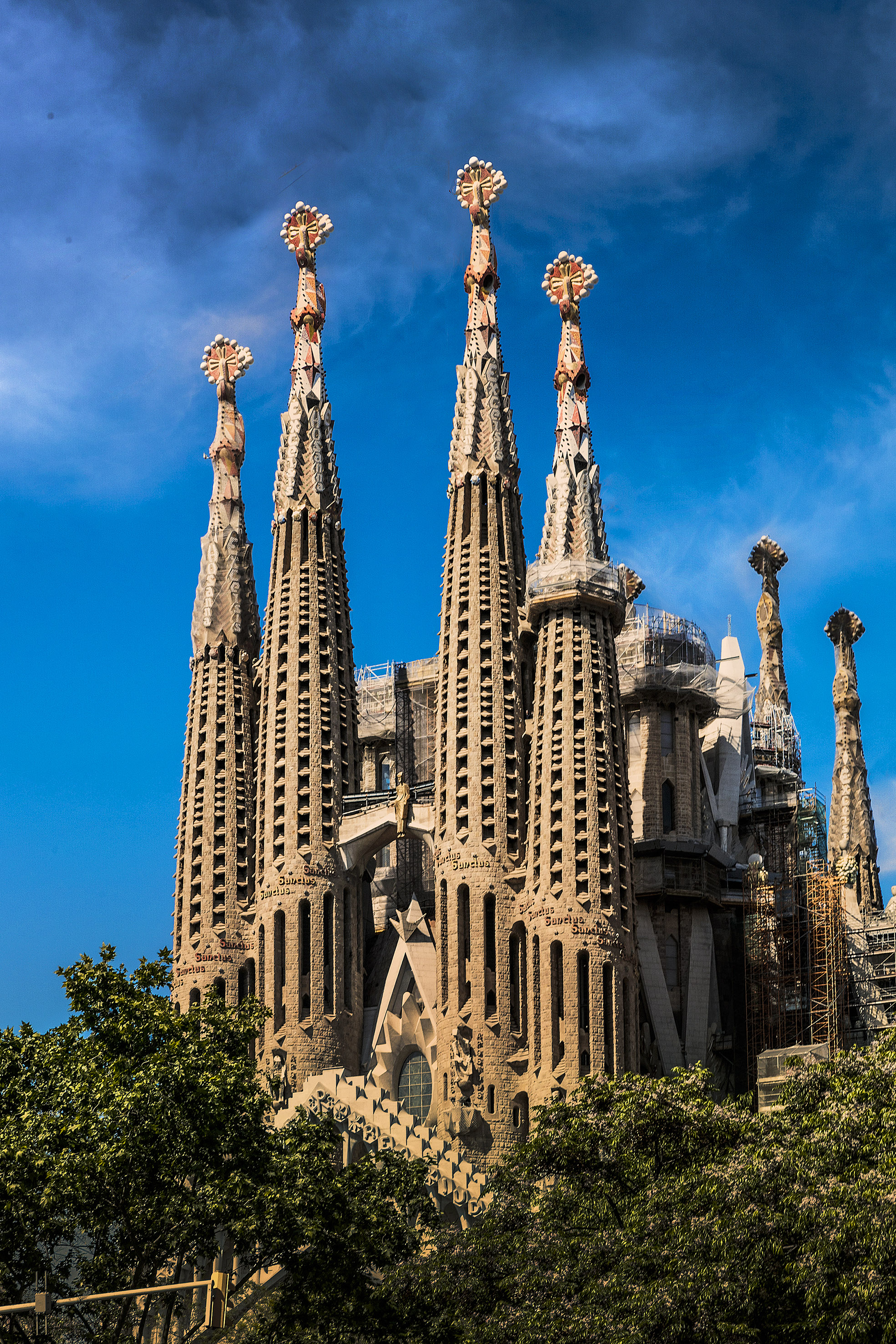 a large building with many spires with Sagrada Família in the background