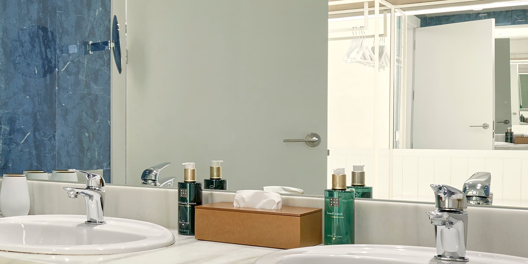 a bathroom with sinks and a mirror