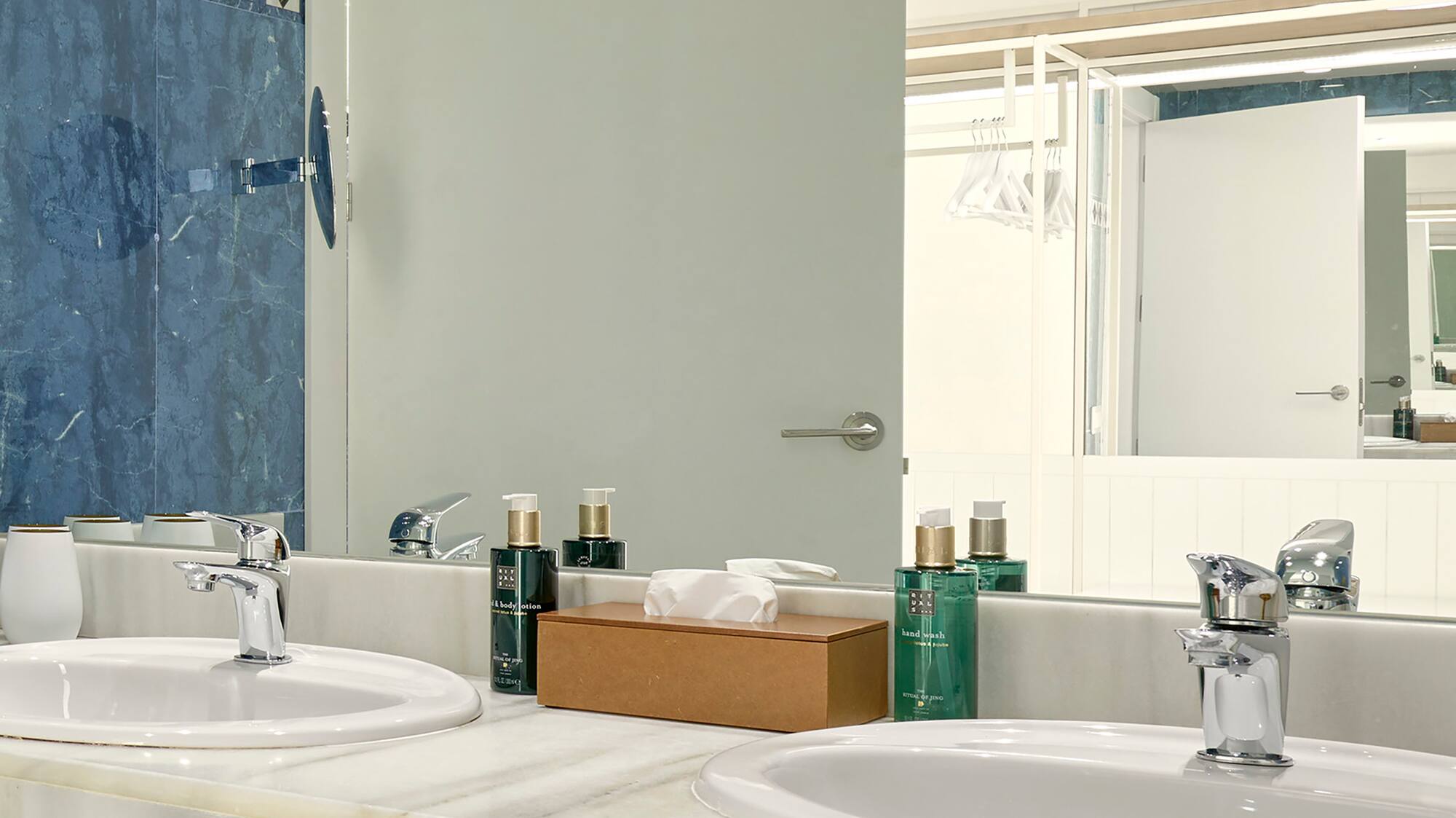 a bathroom with sinks and a mirror