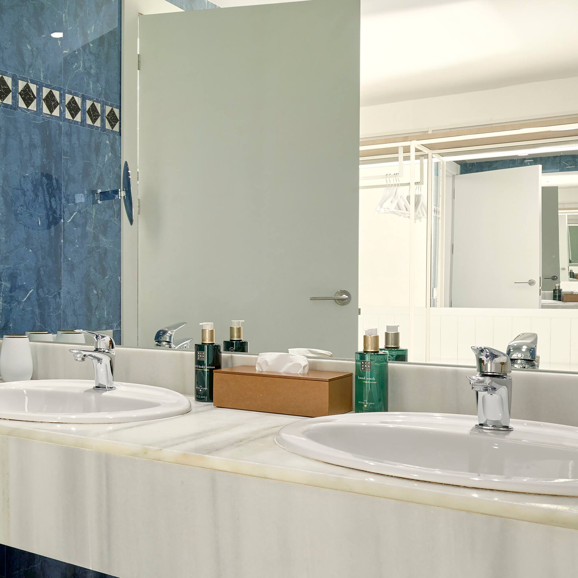 a bathroom with sinks and a mirror