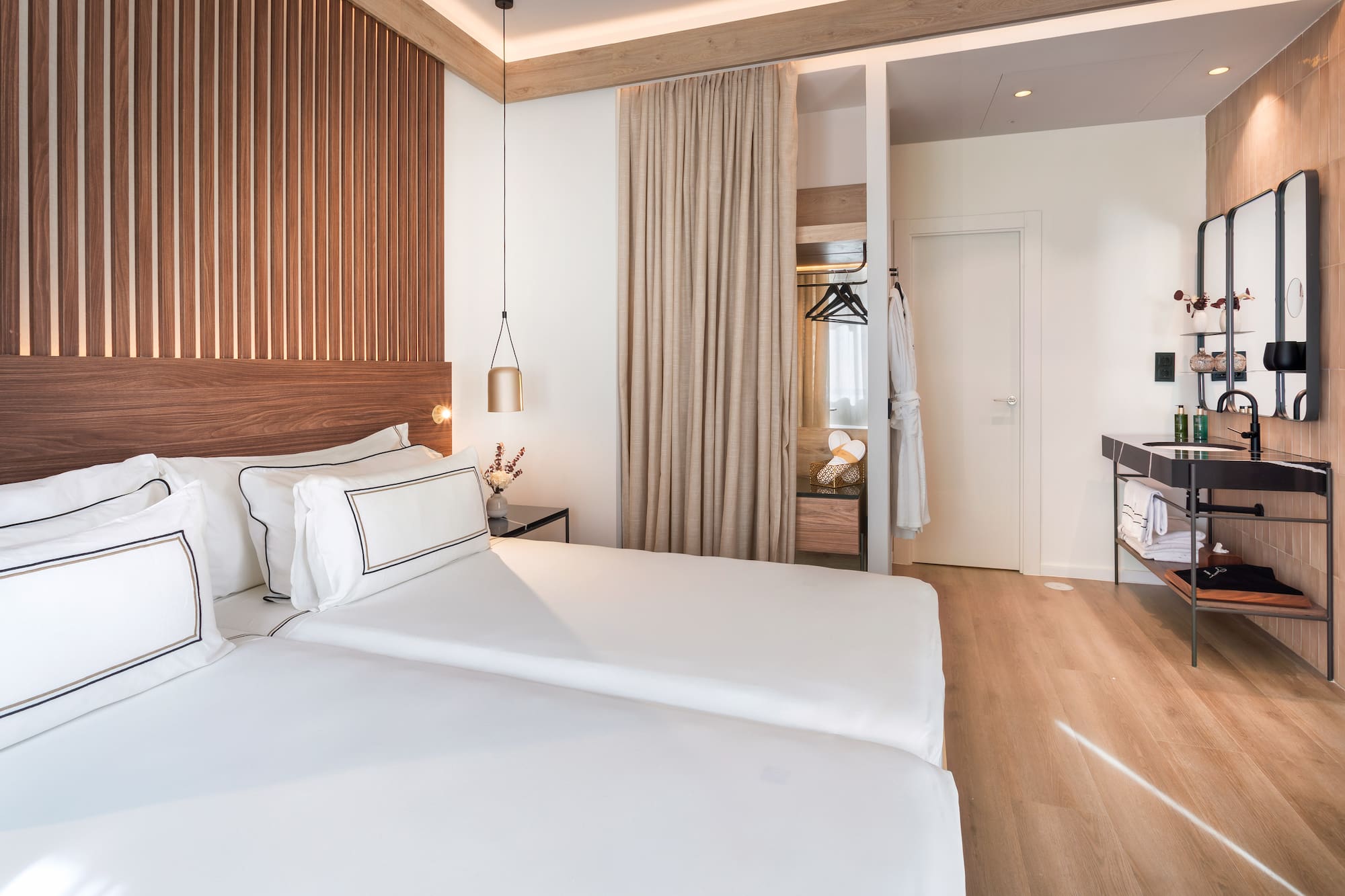 a room with two beds and a wood floor