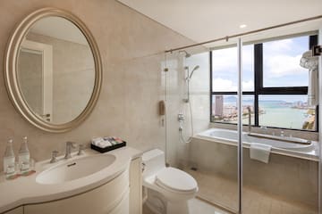 a bathroom with a glass shower door and a tub