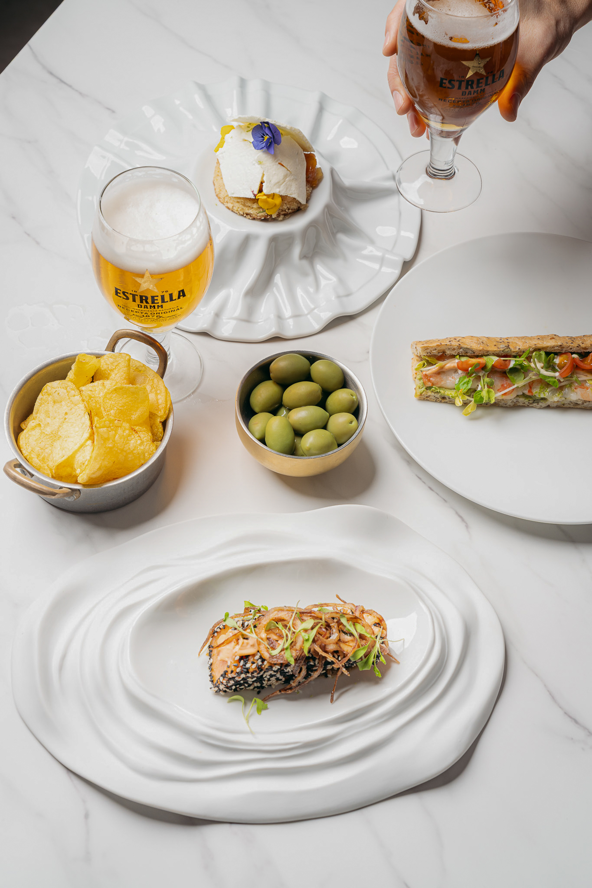a table with plates of food and drinks