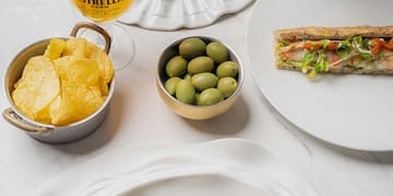 a table with plates of food and drinks