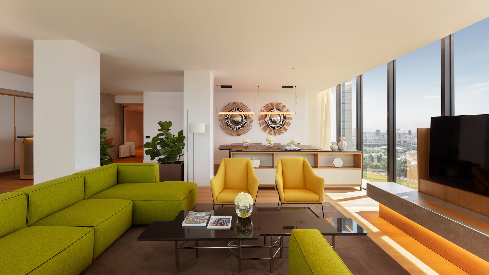 Modern living room with green sofa, yellow chairs, and city view.