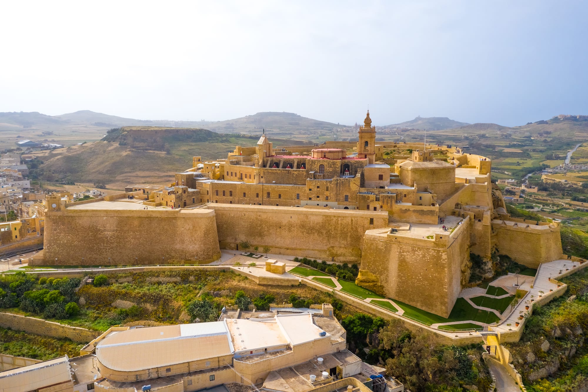Fortified Gozo Cittadella, Malta: stone city with bell tower, aerial view.