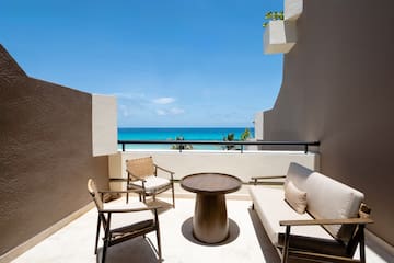 a patio with chairs and a table