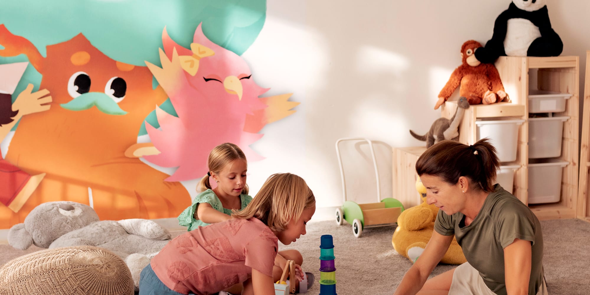 a woman and two girls playing with toys