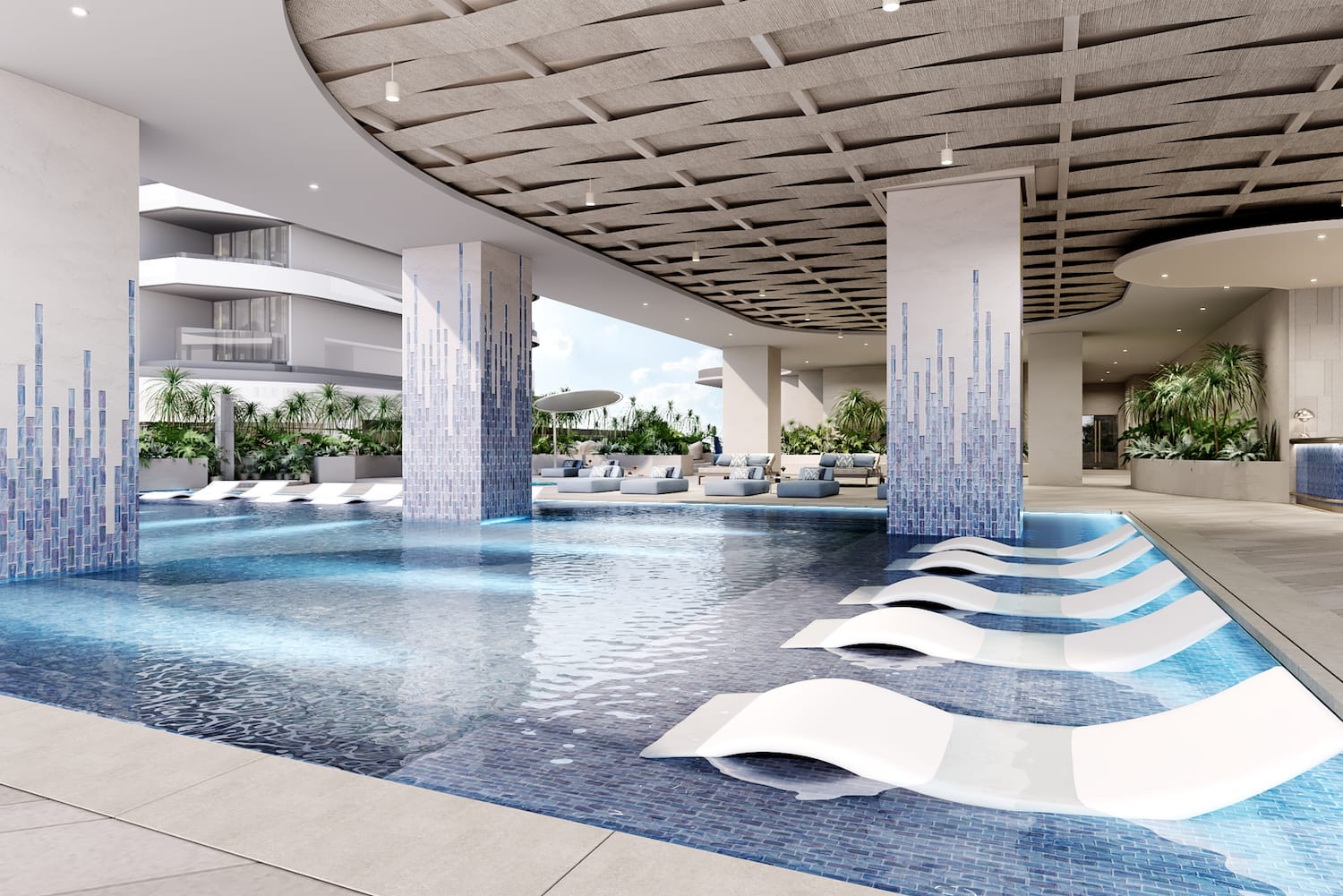 a pool with lounge chairs in a building
