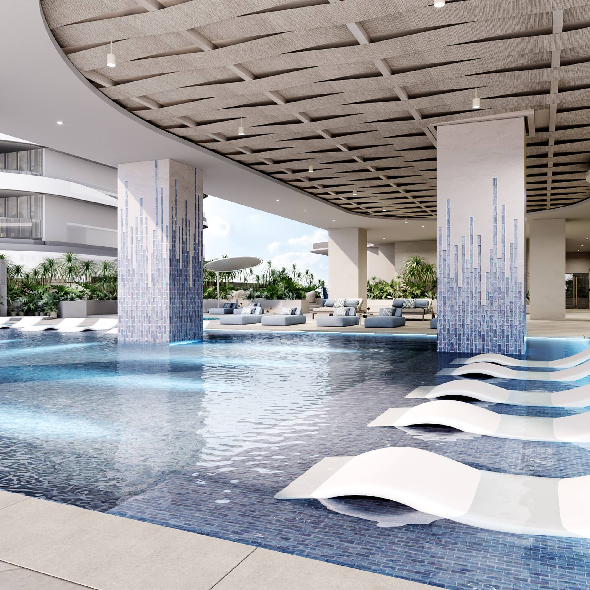 a pool with lounge chairs in a building