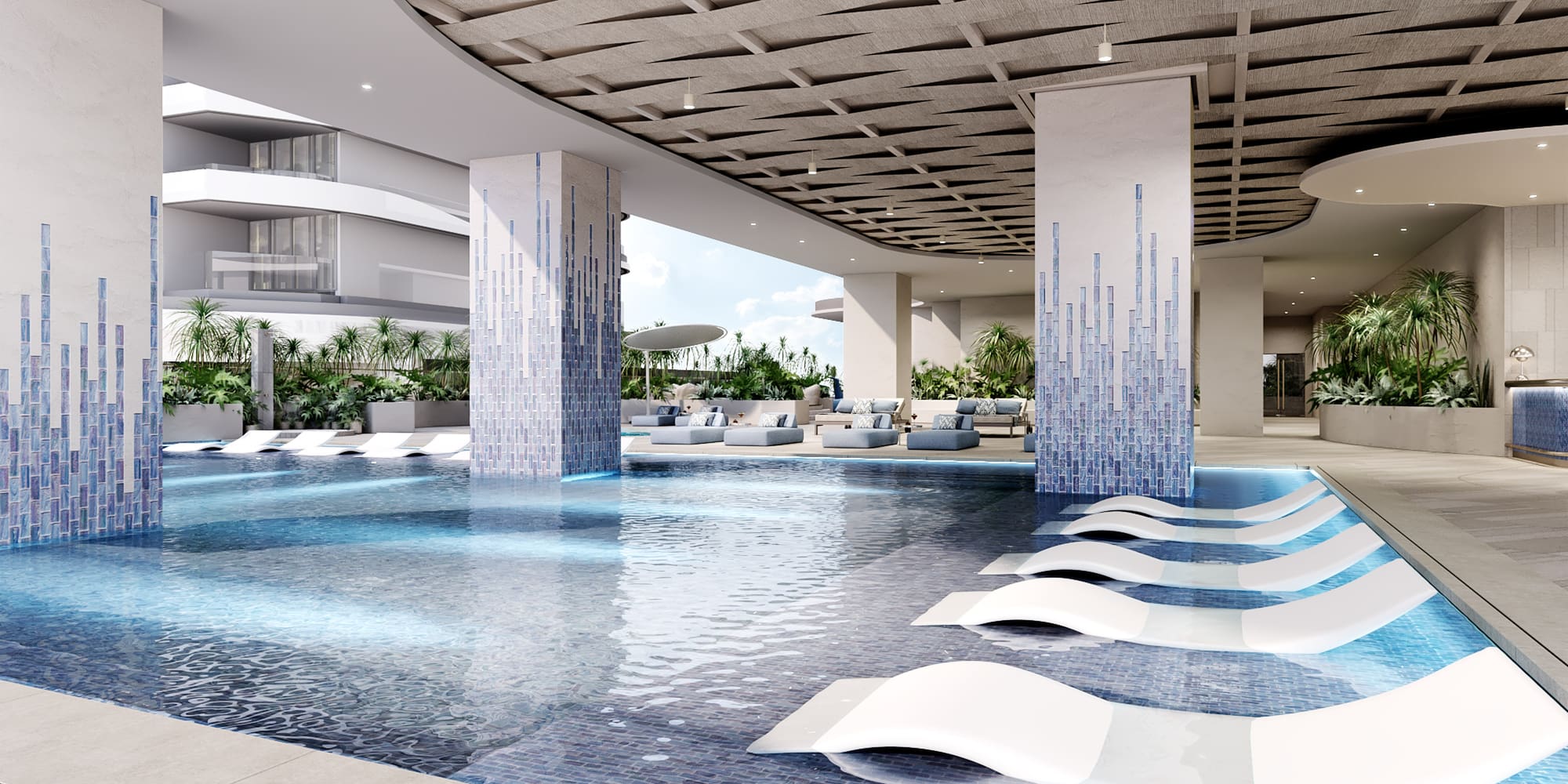 a pool with lounge chairs in a building