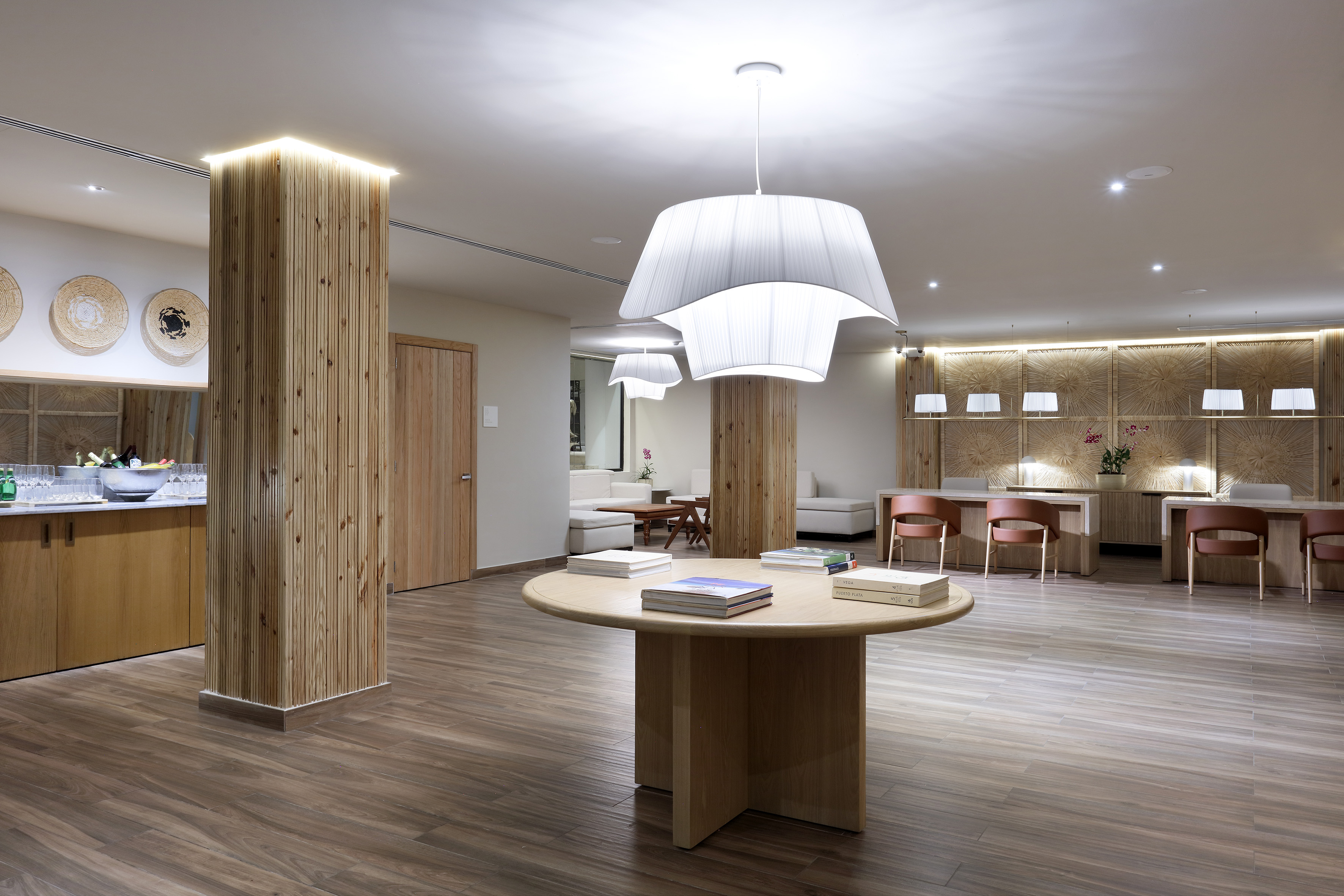 Modern hotel lobby with wood, contemporary lighting, and a reception desk.
