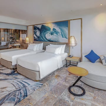 a room with two beds and a round bed