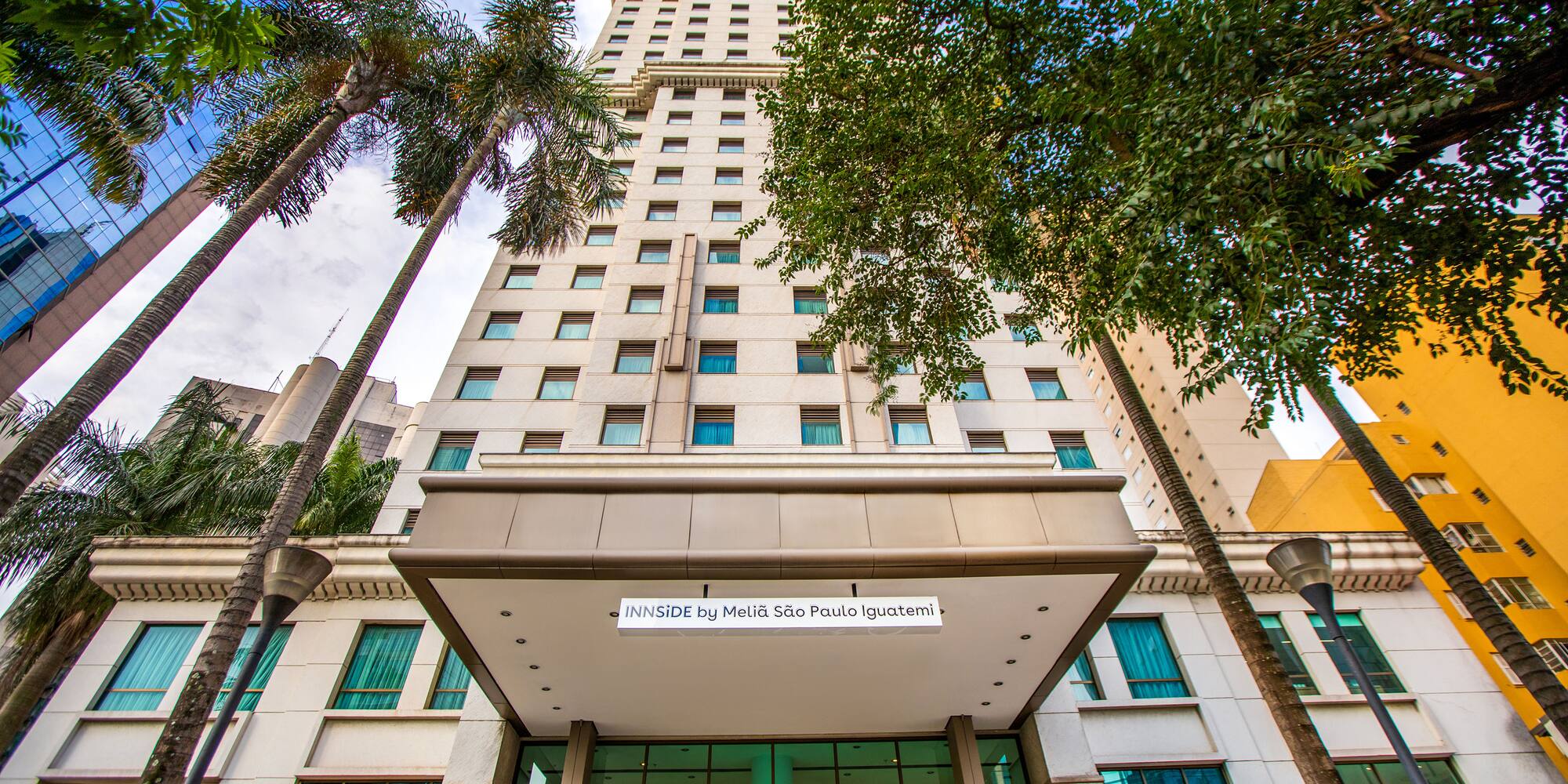 a tall building with trees in front