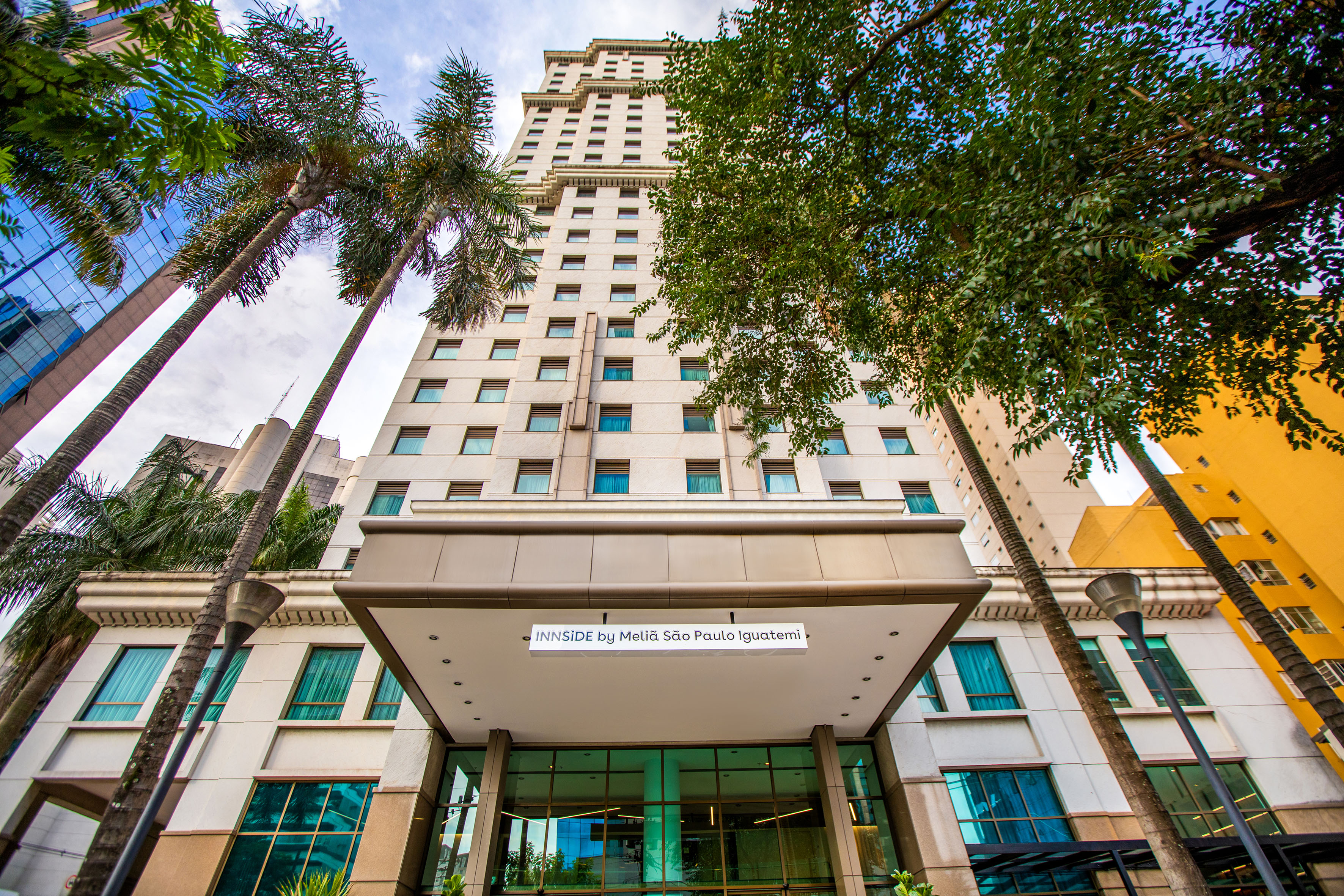 a tall building with trees in front